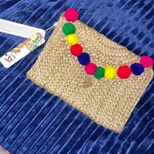 Woven multi color puff clutch.